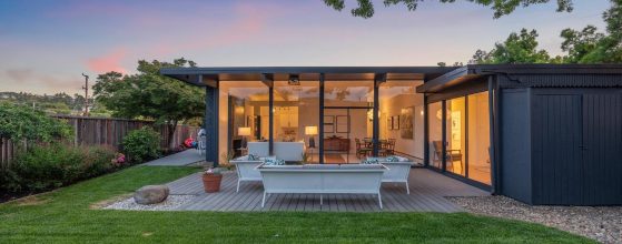 Looking into a warmly lit San Rafael Eichler home in Marin County at sunset.